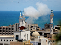 Smoke billows from the port of Gaza following an Israeli naval bombardment on May 17, 2021. - Israeli air strikes hammered the Gaza Strip af...