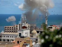Smoke billows from the port of Gaza following an Israeli naval bombardment on May 17, 2021. - Israeli air strikes hammered the Gaza Strip af...