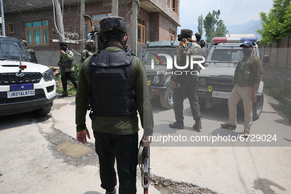 Indian forces stand near encouter site in Khonmuh area of Pampore district south of Srinagar, Indian Administered Kashmir on 17 May 2021. Tw...