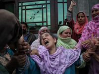 Kashmiri women wail outside the damaged residential house after encounter between Indian Forces and Alledged militants was over in Khonmuh a...
