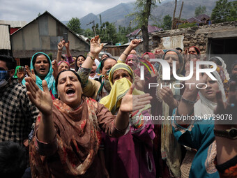 Kashmiri women shout Pro-Freedom slogans outside the damaged residential house after encounter between Indian Forces and Alledged militants...