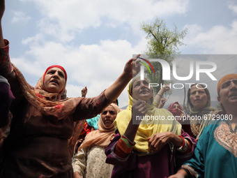 Kashmiri women shout Pro-Freedom slogans outside the damaged residential house after encounter between Indian Forces and Alledged militants...