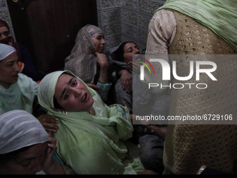 Kashmiri women wail inside the damaged residential house after encounter between Indian Forces and Alledged militants was over in Khonmuh ar...