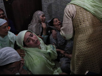 Kashmiri women wail inside the damaged residential house after encounter between Indian Forces and Alledged militants was over in Khonmuh ar...