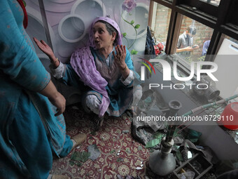 A woman wails inside a damaged residential house after encouter between Indian Forces and alledged militants was over in Khonmuh area of Pam...