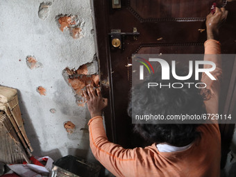 A man cleans the blood stains inside a damaged residential house after encouter was over in Khonmuh area of Pampore district south of Srinag...