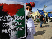 A demonstrator carries a placard in support of Palestine during a rally in Lisbon. May 17, 2021. The Portuguese Council for Peace and Cooper...