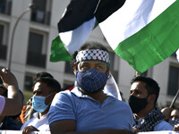 A protester carrying a Palestinian flag shouts slogans against Israel during a rally in Lisbon. May 17, 2021. The Portuguese Council for Pea...