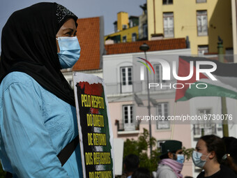 A demonstrator carries a placard in support of Palestine during a rally in Lisbon. May 17, 2021. The Portuguese Council for Peace and Cooper...