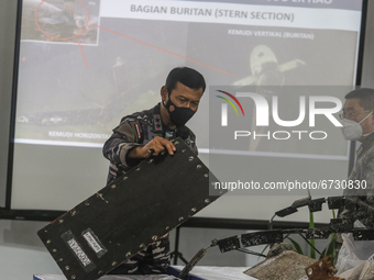 Indonesian Navy officer Rear Admiral of TNI Iwan Isnurwanto (left) shows some parts of sunken Indonesian Navy submarine KRI Nanggala 402 dur...