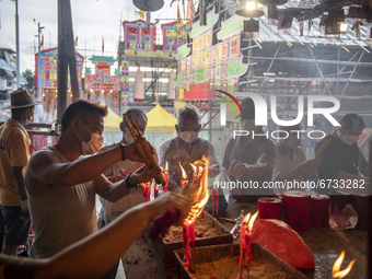 Worshippers burn insect sticks at a temple in Cheung Chau in Hong Kong, Monday, May 17, 2021. Cheung Chau Bun Festival or Cheung Chau Da Jiu...