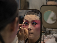 A Chinese Opera Singer puts on make-up before Cantonese Opera show, in Cheung Chau in Hong Kong, Monday, May 17, 2021. Cheung Chau Bun Festi...