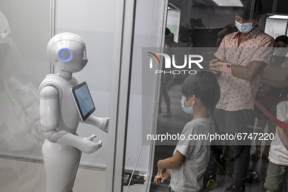 Visitors looks at an exhibition item at the “Robots, The 500-Year Quest to Make Machines Human