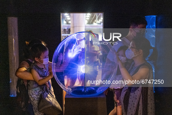 Visitors interact with an exhibition item about electricity in the Hong Kong Science Museum, in Hong Kong, China on May 22, 2021. 