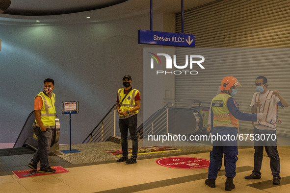 Authorities gather at KLCC station after an accident involving Kuala Lumpur Light Rail Transit (LRT) trains in Kuala Lumpur on May 24, 2021....