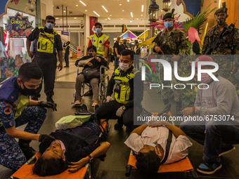 Rescue personnel help injured passengers at KLCC station after an accident involving Kuala Lumpur Light Rail Transit (LRT) trains in Kuala L...