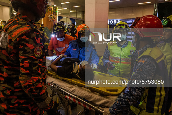 Rescue personnel help injured passengers at KLCC station after an accident involving Kuala Lumpur Light Rail Transit (LRT) trains in Kuala L...