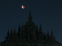 Super Blood Moon are seen above an ancient Plaosan Buddhist temple complex, Central Java, on May 26, 2021. The Super Blood Moon occurs when...