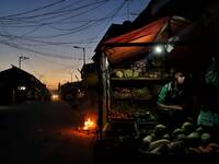 A Vendor waits for the customers during an Evening as Traders are not allowed to open their shops during the day due to COVID-19 Coronavirus...