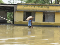 A man carrying food grains through submerged area to a relief camp.  On May 28, 2021 in West Bengal, India. According to report more than th...