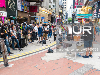 An activist talks to a host of livestreamers in Causeway Bay, under close supervision of the police, in Hong Kong, China, on May 30, 2021. (