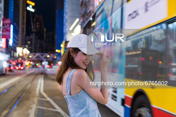 Young ladies take selfies in Causeway Bay, in Hong Kong, China, on May 30, 2021. 