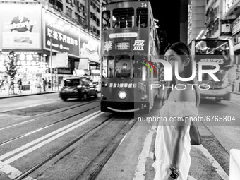 (EDITOR'S NOTE: Image was converted to black and white) A young lady poses in Causeway Bay, in Hong Kong, China, on May 30, 2021. (