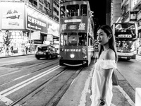 (EDITOR'S NOTE: Image was converted to black and white) A young lady poses in Causeway Bay, in Hong Kong, China, on May 30, 2021. (