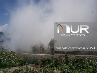 Smoke rises as firefighters try to douse a fire on a pile of wires at the premises of Waste Management Section in Kathmandu, Nepal on June 3...