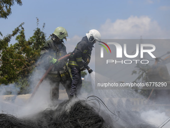 Firefighters try to douse a fire on a pile of wires at the premises of Waste Management Section in Kathmandu, Nepal on June 3, 2021. (
