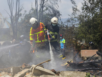 Firefighters try to douse a fire on a pile of wires at the premises of Waste Management Section in Kathmandu, Nepal on June 3, 2021. (