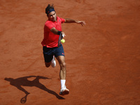 Roger Federer of Switzerland heats the ball during the second round match against Marin Cilic of Croatia during day five of the 2021 French...