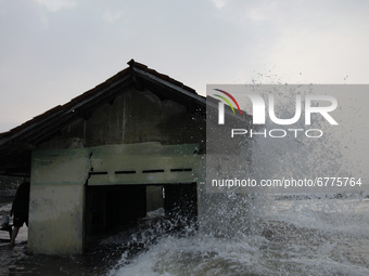 waves hit an abandoned house in the village of northern coastal of Pekalongan city, Central Java, on June 3, 2021. Base on data from the geo...