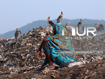 A woman ragpicker sitting near a garbage-heap at Boragaon dumping site, on the eve of World Environment Day, in Guwahati, Assam, India on Fr...