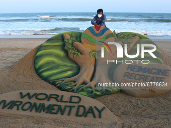 Environment Day sand sculpture is seen at the Bay of Bengal Sea's Puri beach as it is creating by sand artist Sudarshan Patnaik for awarenes...