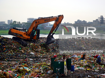 People waste pickers pick the non- biodegradable waste to be used for the recycling industry in dump site in Dhaka, Bangladesh on June 5, 20...