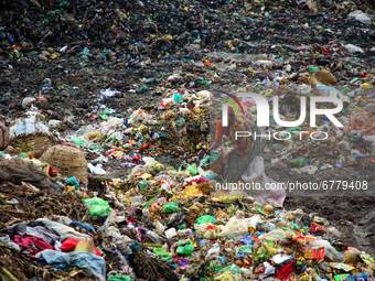 People waste pickers pick the non- biodegradable waste to be used for the recycling industry in dump site in Dhaka, Bangladesh on June 5, 20...