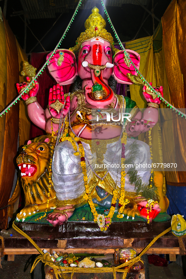 Large clay idol of Lord Ganesha (Lord Ganesh) at a pandal (temporary shrine) along the roadside during the festival of Ganesh Chaturthi in K...