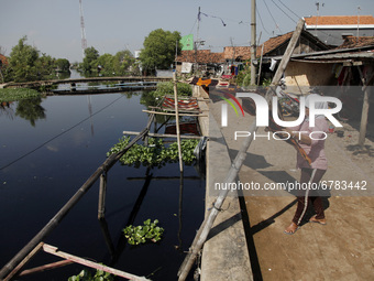 Workers continue to work at batik cloth factory after having paused due to the tidal flood in Jeruk Sari village, Pekalongan city, Central J...