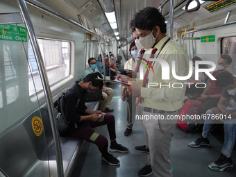 A Delhi Metro Rail Corporation (DMRC) official penalizes a commuter for not following guidelines while travelling inside a Metro train after...