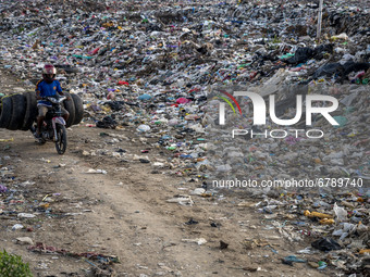A scavenger transports his scavenged tires at the Poi Panda landfill, Kawatuna, Palu City, Central Sulawesi Province, Indonesia on June 8, 2...