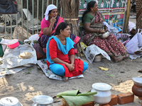 Hindu women finish the final preparations before cooking pongala along the roadside on the morning of the final day of the 10 day-long Attuk...