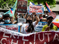 Protesters wearing face masks as protection against the COVID-19 gather in commemoration of 123rd Philippine Independence Day, outside the C...