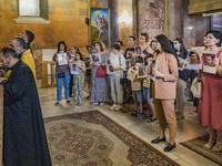Relatives of killed soldiers in the last Nagorno Karabakh conflict with Azerbaijan, attends a holy mass in a church of Yerevan, Armenia, on...