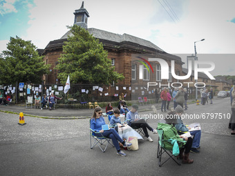 Protestors take part in a library read-in outside Whiteinch Library on June 12, 2021 in Glasgow, Scotland. The protesters are demonstrating...