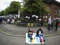 Protestors take part in a library read-in outside Whiteinch Library on June 12, 2021 in Glasgow, Scotland. The protesters are demonstrating...
