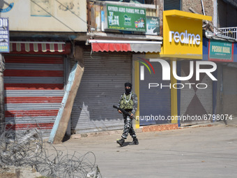 Indian forces stand near shootout spot in Sopore district, North of Srinagar, Indian Administered Kashmir on 12 June 2021. Two civilians and...