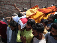 (EDITORS NOTE: Image contains graphic content.) People carry the dead body of a civilian Bashir Ahmad who was killed in a shootout in Sopore...