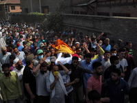 (EDITORS NOTE: Image contains graphic content.) People carry the dead body of a civilian Bashir Ahmad who was killed in a shootout in Sopore...