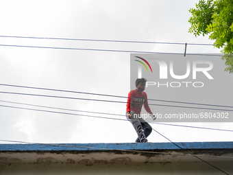 An employee of an Internet wired broadband service provider is providing internet connection through Internet Cable at Tehatta, West Bengal,...